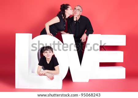 Happy family, three of them with the words Love. studio photography