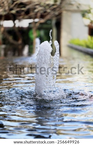 small fountain water jet photographed close up