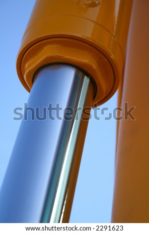 The chromeplated piston of hydraulic system of a dredge on a background of the blue sky, Isolated (look similar images in my portfolio)