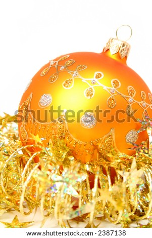 New Year\'s sphere of orange color and celebratory tinsel on a white background, (look similar images in my portfolio)