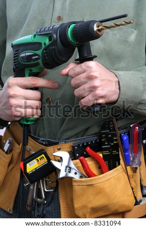 man with drill and tool belt