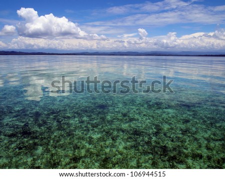 Calm sea in shallow water with cloud reflected on water surface, Caribbean, Panama