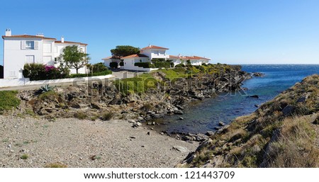Panorama on a tranquil cove of the Mediterranean sea with waterfront house, village of Cadaques, Costa Brava, Catalonia, Spain