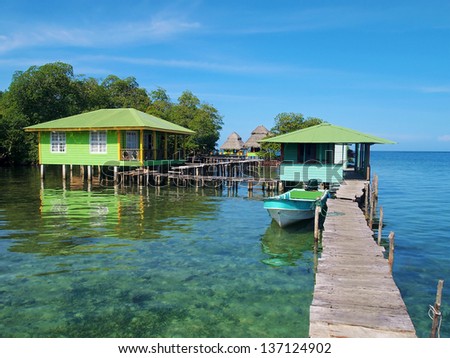 Tropical resort over the water with wooden dock and bungalows, Caribbean sea, Bocas del Toro, Panama