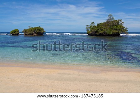 Tropical sandy beach with clear water and small islands off the shore,  Caribbean sea, Panama