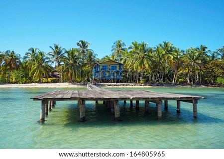 Tropical coastline with beach house and its dock, Caribbean sea