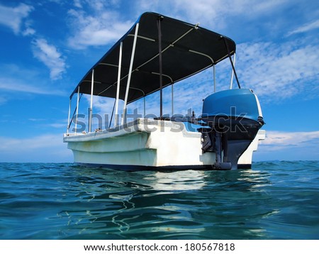 From water surface, typical Panga boat with bimini top in the Caribbean sea, Bocas del Toro, Panama, Central America