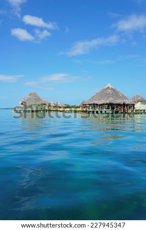 Tropical resort over the sea with thatched roof cabins and restaurant, Caribbean, Central America, Panama