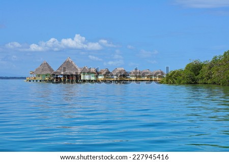 Eco resort over water with thatched cabins in the Caribbean sea, Panama