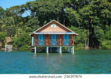 Bungalow over water with tropical vegetation in background, Caribbean sea, Bocas del Toro, Panama