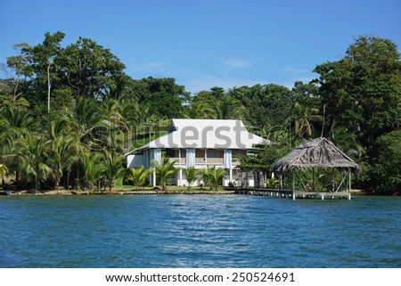Waterfront property with a Caribbean house and thatched hut over the sea, Bocas del Toro, Panama, Solarte island