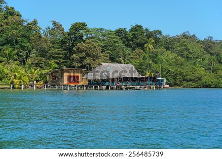 Tropical restaurant with thatched roof and a cabin over the water, island of Bastimentos, Caribbean, Bocas del Toro, Central America, Panama