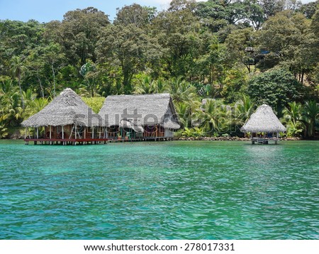 Lush tropical shore with small eco resort over the Caribbean sea in Panama, Bocas del Toro, Central America