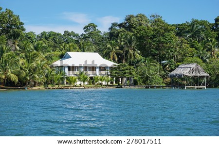 Oceanfront property with a Caribbean house and a tropical hut over the water, Bocas del Toro, Panama, Central America