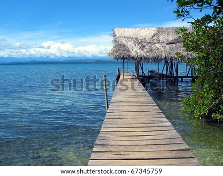Dock with boathouse and dugout canoe over the Caribbean sea, Bocas del Toro, Panama