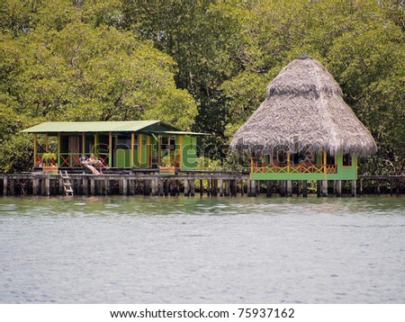 Tropical bungalow over the sea with mangrove trees in background, Caribbean, Bocas del Toro, Panama