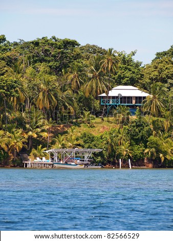 Tropical land at the edge of the Caribbean sea with a dock and an house, Bocas del Toro, Panama