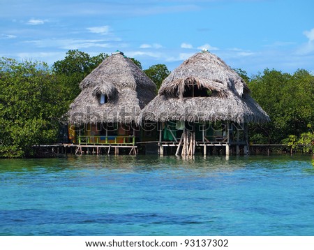 Tropical huts over the water with thatched roof, Caribbean sea, Panama