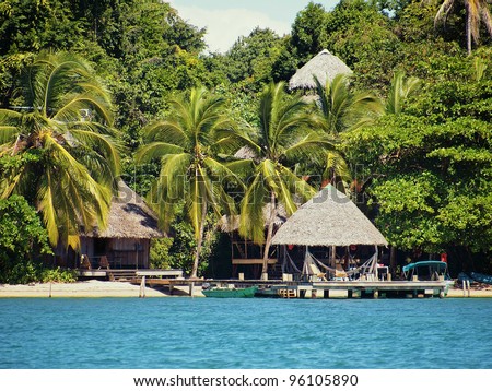 Eco resort on a Caribbean beach with thatched huts and lush tropical vegetation, Bocas del Toro, Panama