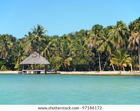 Tropical beach with thatch hut overwater, Caribbean sea, Panama