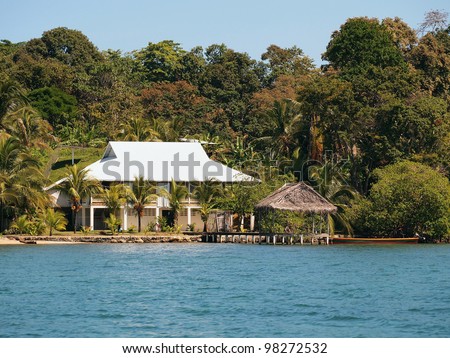 Waterfront Caribbean house with a tropical hut over water and jungle in background, Bocas del Toro, Panama