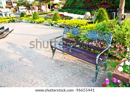 the green bench in the flower garden