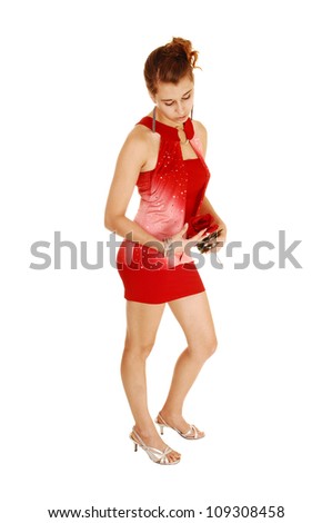 A pretty woman from the side in a red short and tight dress, holding a rose, standing in high heels for white background with her lovely figure.