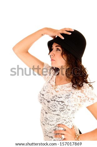A lovely slim young woman in a beige blouse, wearing a black hat in profile for white background.