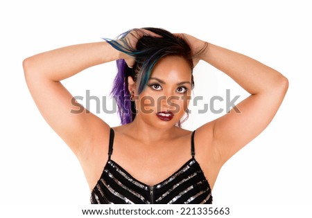 A beautiful Asian woman in a black dress, with her hands behind  her head messing with her hair, standing isolated for white background.