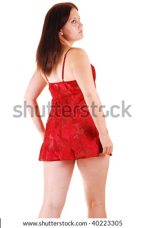 An young woman in red short lingerie standing in the studio showing her nice round butt and legs, on white background.