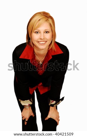 An friendly blond girl in an red blouse and black jacket standing in an studio for white background.