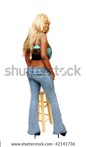 stock photo An busty young Jamaican girl in jeans whit long blond hair and