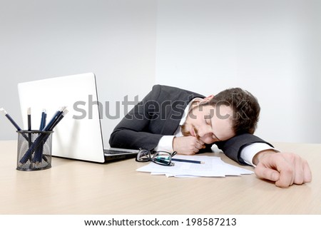Young business man sleeping on the office desk