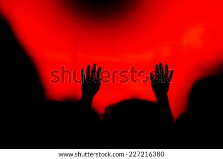 Silhouette of cheering hands from the crowd on concert