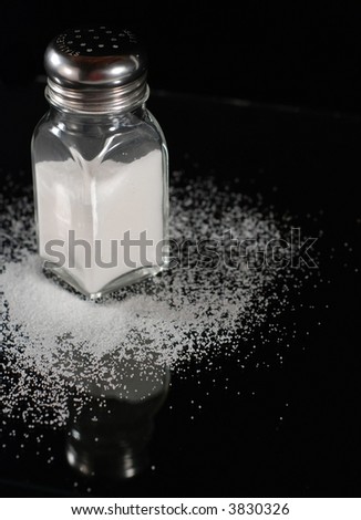 salt shaker with spilled salt