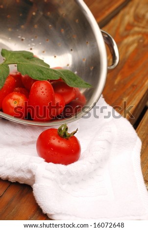 cherry tomato with grape tomatoes in a colander
