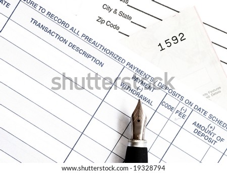 closeup of check register and pen nib