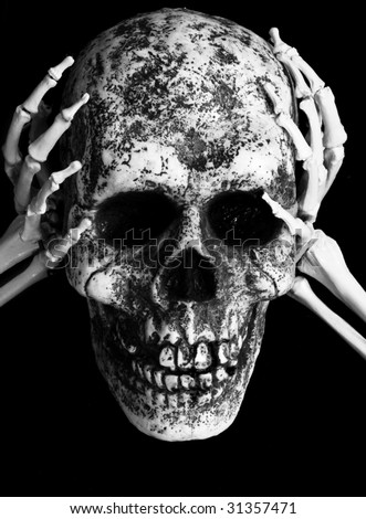 skeletal hands holding skull