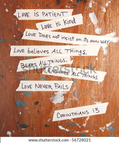 Corinthians 13 written on masking tape stuck to an old board - stock photo