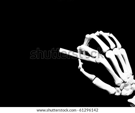 skeleton hand ready to write on a blank blackboard