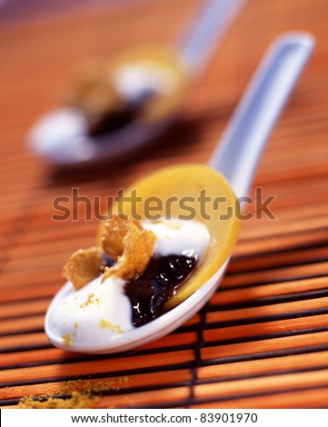 Spoonful of mascarpone with blackberries,cereals and mild curry