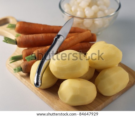 Raw carrots, potatoes and small onions