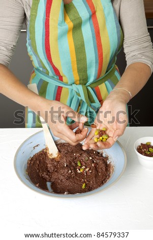 Adding the dried fruit to the chocolate paste