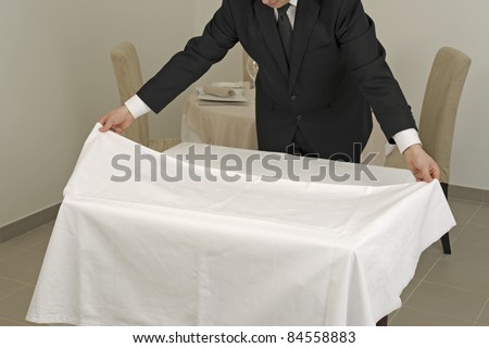 Putting the tablecloth on a square table