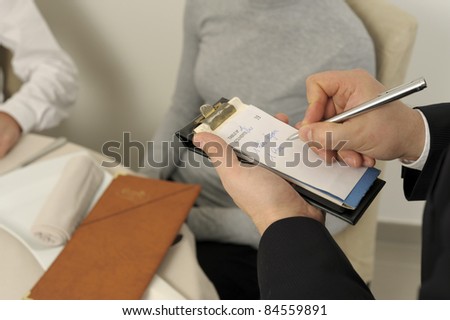 Waiter taking an order from clients in a restaurant
