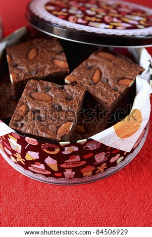 Almond and chocolate chip brownies in a tin box