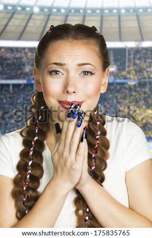 Excited woman fan watching competition or concert in stadium