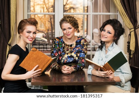 Three women friends in cafe