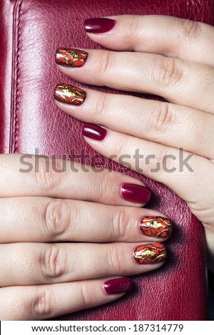 close-up of female hands with painted nail polish on the background clutch