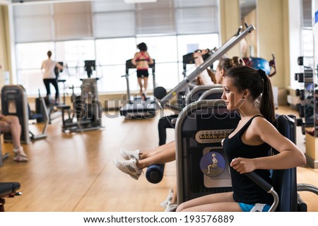 Gym fitness club indoor with young women training weights with hands